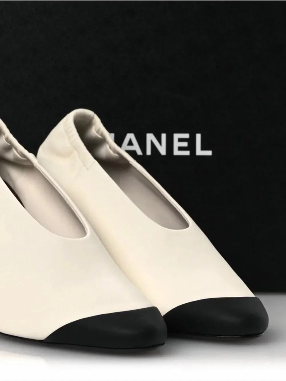 CHANEL Two-Tone White Leather Pumps with Black Cap Toe